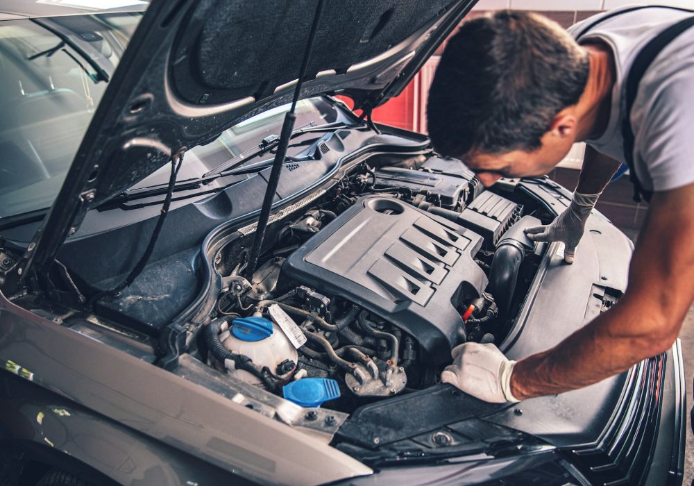 Auto mechanic working in garage